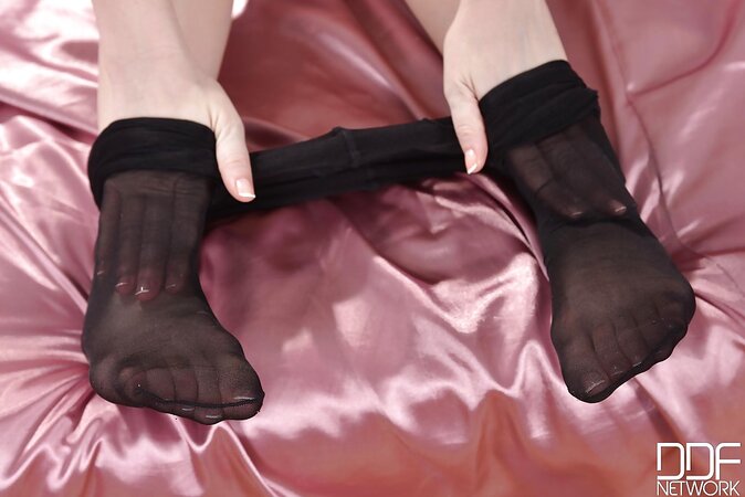 Blonde girl Brookie G plays with her feet and slowly takes pantyhose off