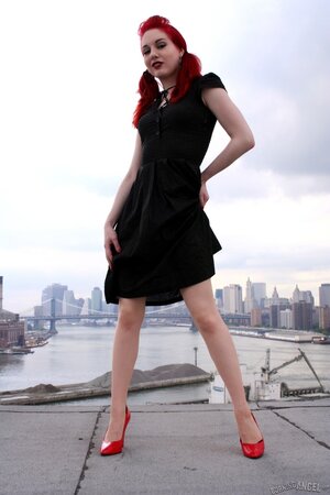 Tempting teen with red hair and high heels takes her black dress off on a roof