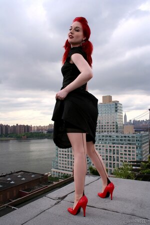 Tempting teen with red hair and high heels takes her black dress off on a roof