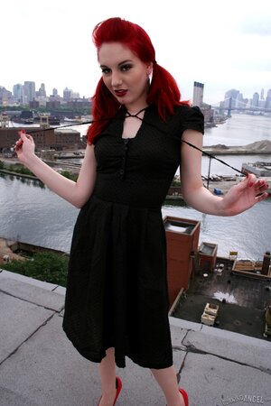 Tempting teen with red hair and high heels takes her black dress off on a roof