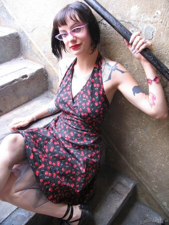 Female with glasses and piercing in clitoris demonstrates her naked body