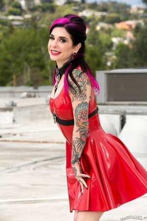 Whore with pink locks in a red vinyl dress goes outdoors for a naked photoshoot