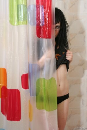 Brunette young woman with glasses finds the perfect place to pose naked