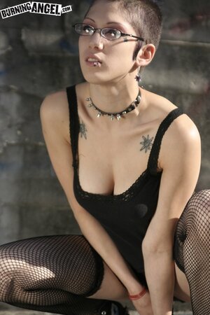Sexy goth girl with glasses and mohawk shamelessly exposes her pussy outdoors