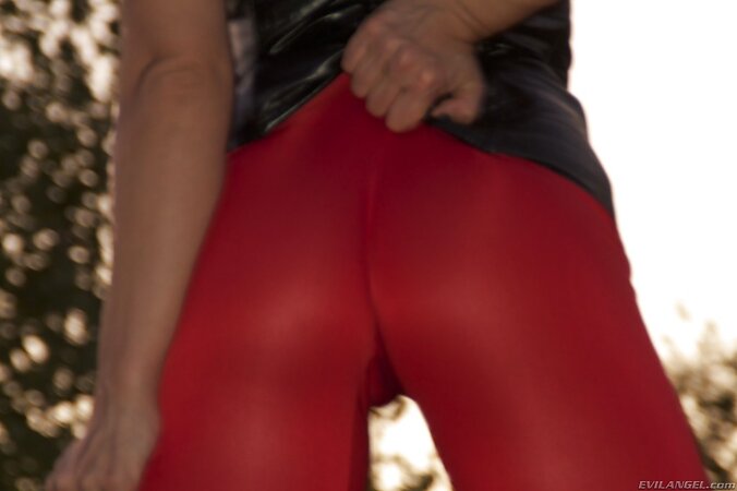 Mysterious blonde MILF in red tights and leather choker bares tits outdoors