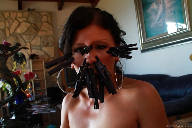 Woman demonstrates clothespins all over her face and a tail in her tushy