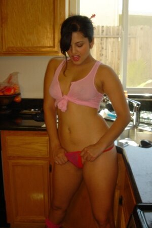 Indian MILF with pierced nipples takes off transparent lingerie in the kitchen