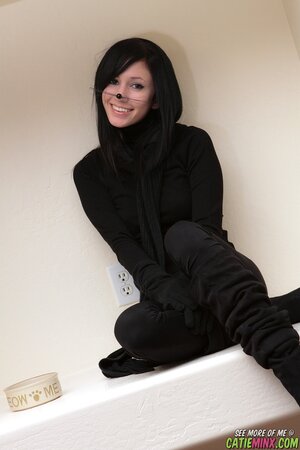 Adorable brunette poses like a kitty who loves to show assets on the camera