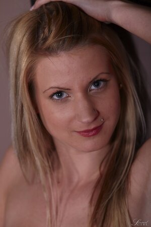 Slender blonde performs amazing strip show for lover on the red couch