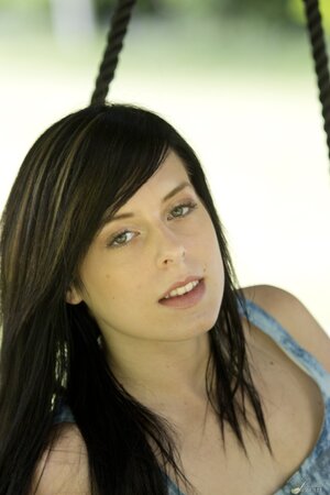 Seductive tender brunette undressing to show her awesome pussy on a swing