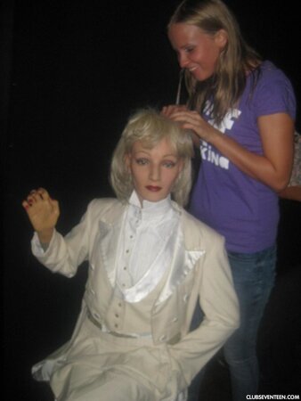 Blonde girl thinks about sex even when she is at the exhibition of wax figures