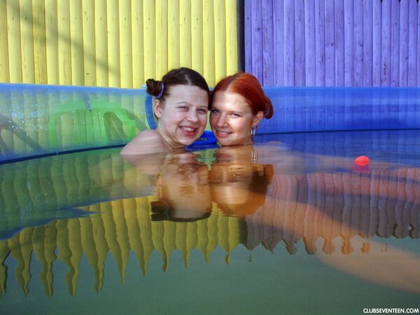 Lesbian teen with nice hairstyle dildoes redhead's pussy in air pool