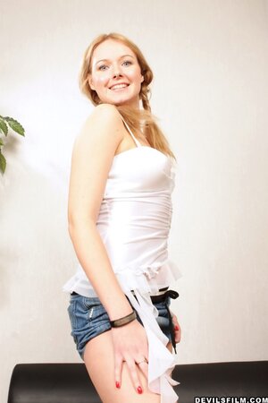 Pretty girl with beautiful smile Marnie stretched all over couch by stud