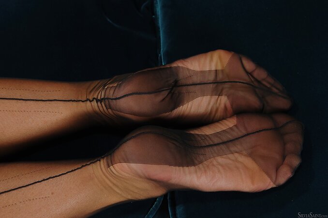 Girl teases fans on posh futon slowly taking clothing items down one by one