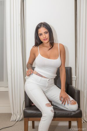 Babe takes white jeans and top off flaunts her curvy inked body naked