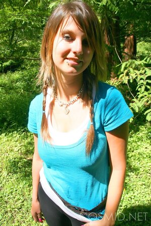 Slim hussy with sexy piercing shows her enormous tits on a sunny day outdoors