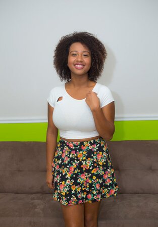Sweet Ebony model reveals her lovely saggy breasts and cute shaved pussy