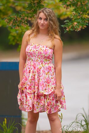 Beauty with wavy hair flashes her natural tits and lovely ass outdoors