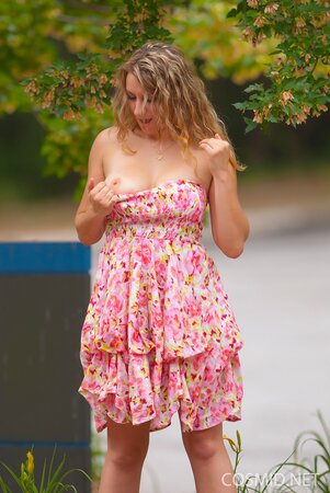 Beauty with wavy hair flashes her natural tits and lovely ass outdoors