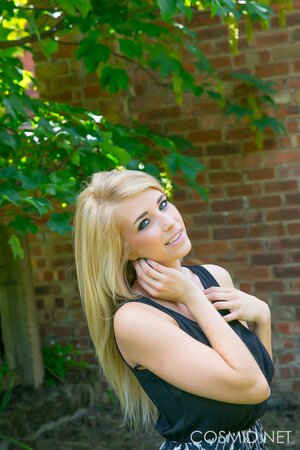 Blonde demonstrates her massive natural breasts and round ass outdoors