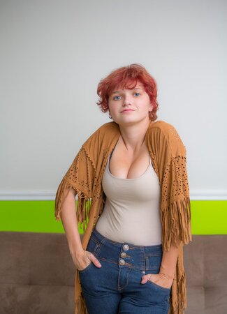 Amateur redhead model spreads legs to reveal her pink shaved pussy on the couch