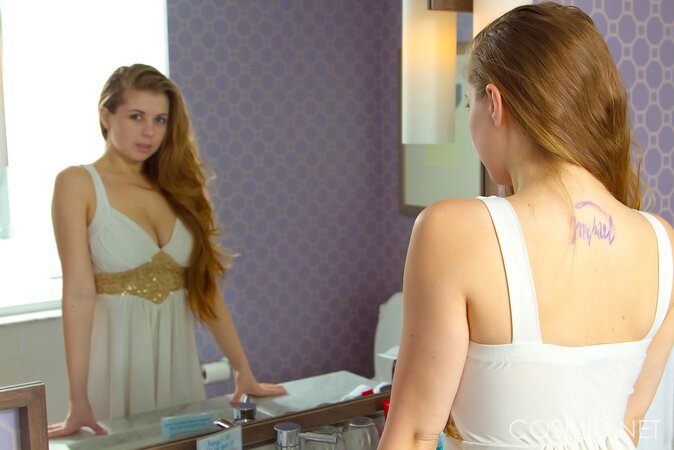 Young amateur nympho comes to the bathroom to pose with her big tits revealed