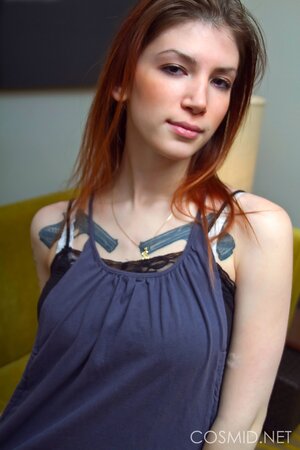 Slim bitch with sexy tattoos gets rid of all clothes and shows impressive tits