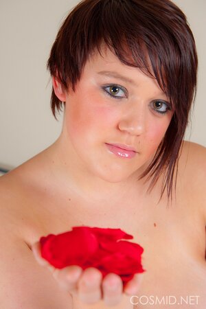 Pudgy hottie with beads shakes her immense natural tits on the bed of roses