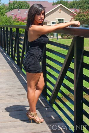 Amateur whore in slinky dress teases with her big tits when posing outdoors