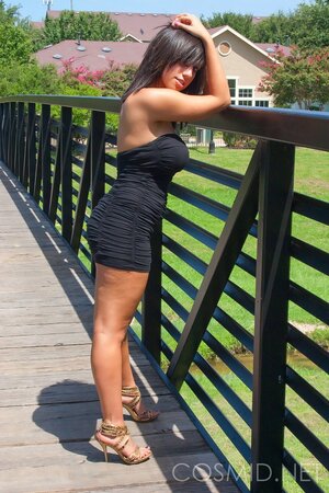 Amateur whore in slinky dress teases with her big tits when posing outdoors