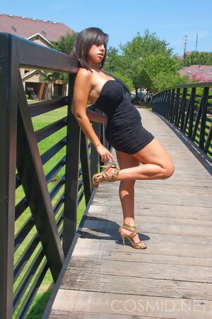 Amateur whore in slinky dress teases with her big tits when posing outdoors