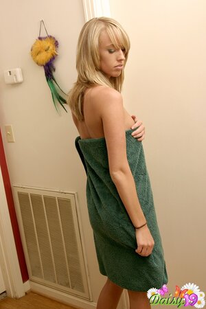 Young lustful hottie removes towel and shows her round ass after taking a shower