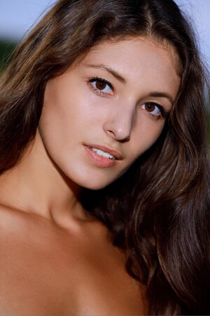 Photographer takes pictures of young model with tan lines in the fresh air