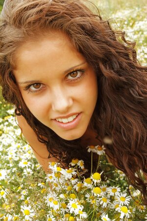 Curly girl adores nature so she wants nude photo session to take place in field