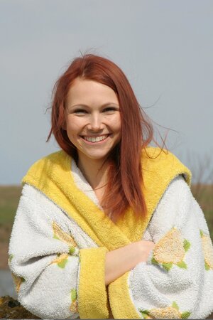 Beautiful outdoor pictures of the pale-skinned naked girl with red hair