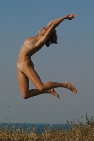 Attractive teen with sexy tan lines relaxes completely naked under the sun