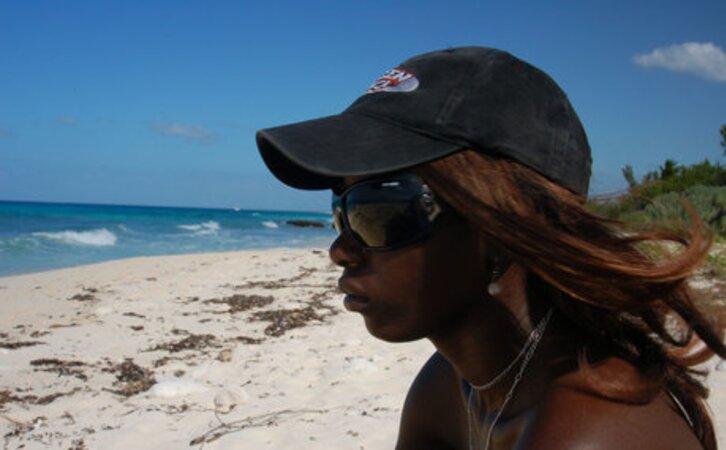 Small-assed black slut with tiny titties gets naked on the rocky shore