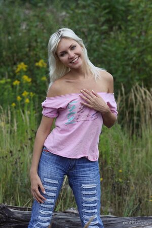 Flighty babe with perky tits takes off jeans to reveal booty in the grass