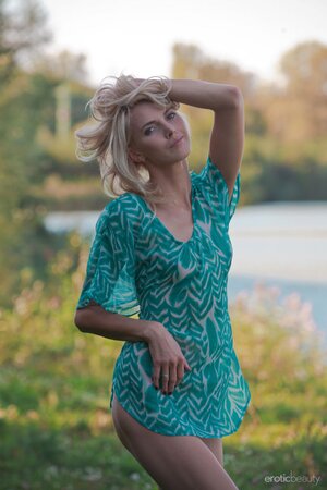 Excited slim blonde poses showing her small boobs and trimmed cunt on the meadow