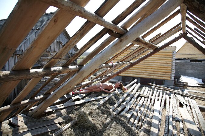 Long-legged nymph peels off sexy lingerie during relax on the roof of a house