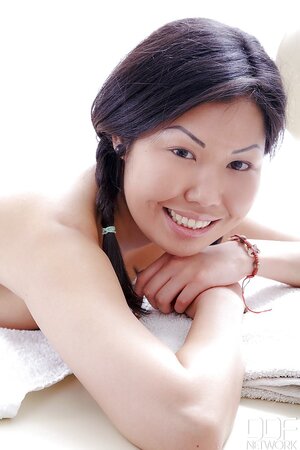 Sexy Asian hussy undresses slowly and flaunts her body on the massage table