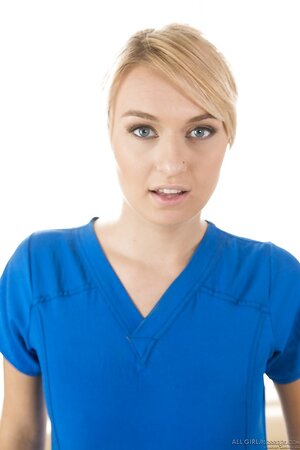Hot blond masseuse poses on the massage table and pulls off her uniform