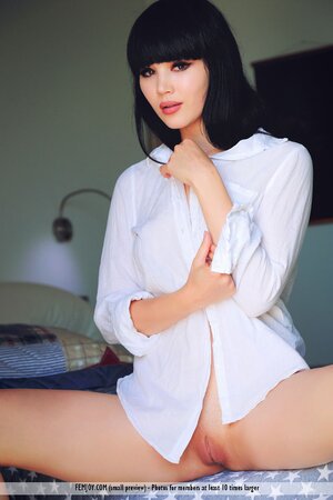 Small-waisted Asian teen spreads her legs really wide to show pink coochie