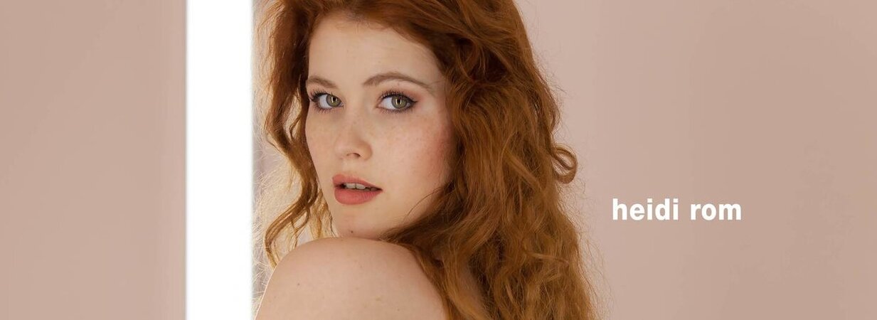 Luscious redhead with curly hair sensually fucks her smooth pussy with sex toy