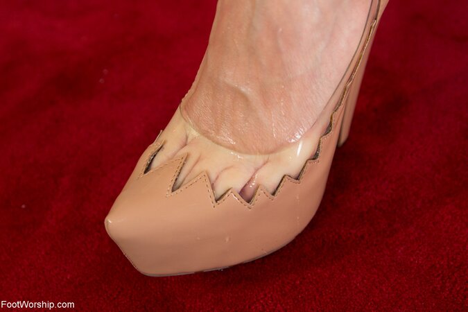 Horny red-haired slut licks high-heeled shoes and oils her cute pink feet