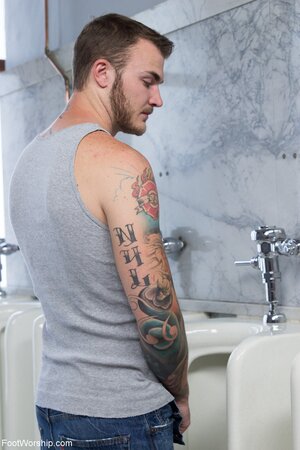 Slutty smoking cougar comes to the men's toilet to pose half-naked there