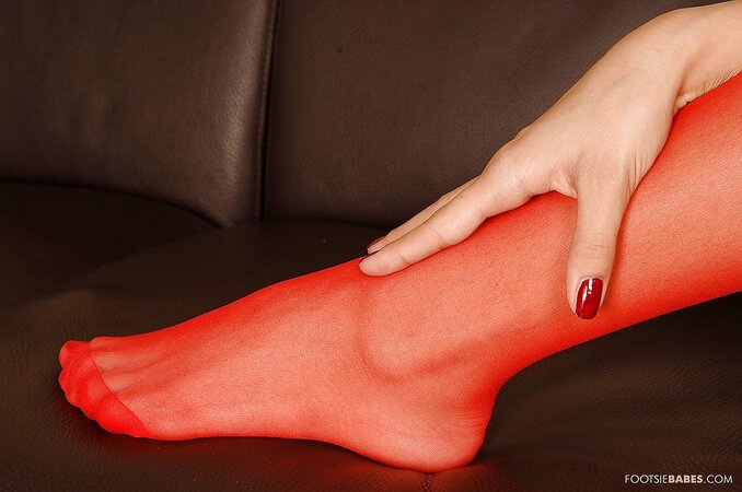 Skinny leggy chick removes red stockings to show feet during masturbation