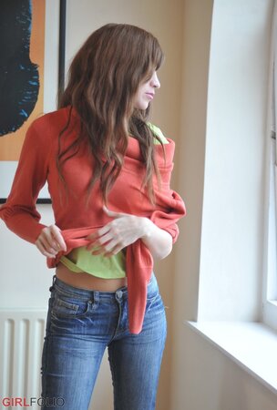 Sensitive brunette girl enjoys herself while revealing underwear by the window