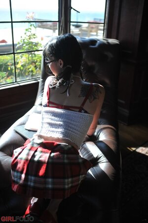 Playful schoolgirl with twin tales isn’t shy to drop her uniform and pose nude