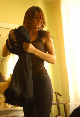 Adorable lassie changes lingerie while erotically posing naked by the mirror